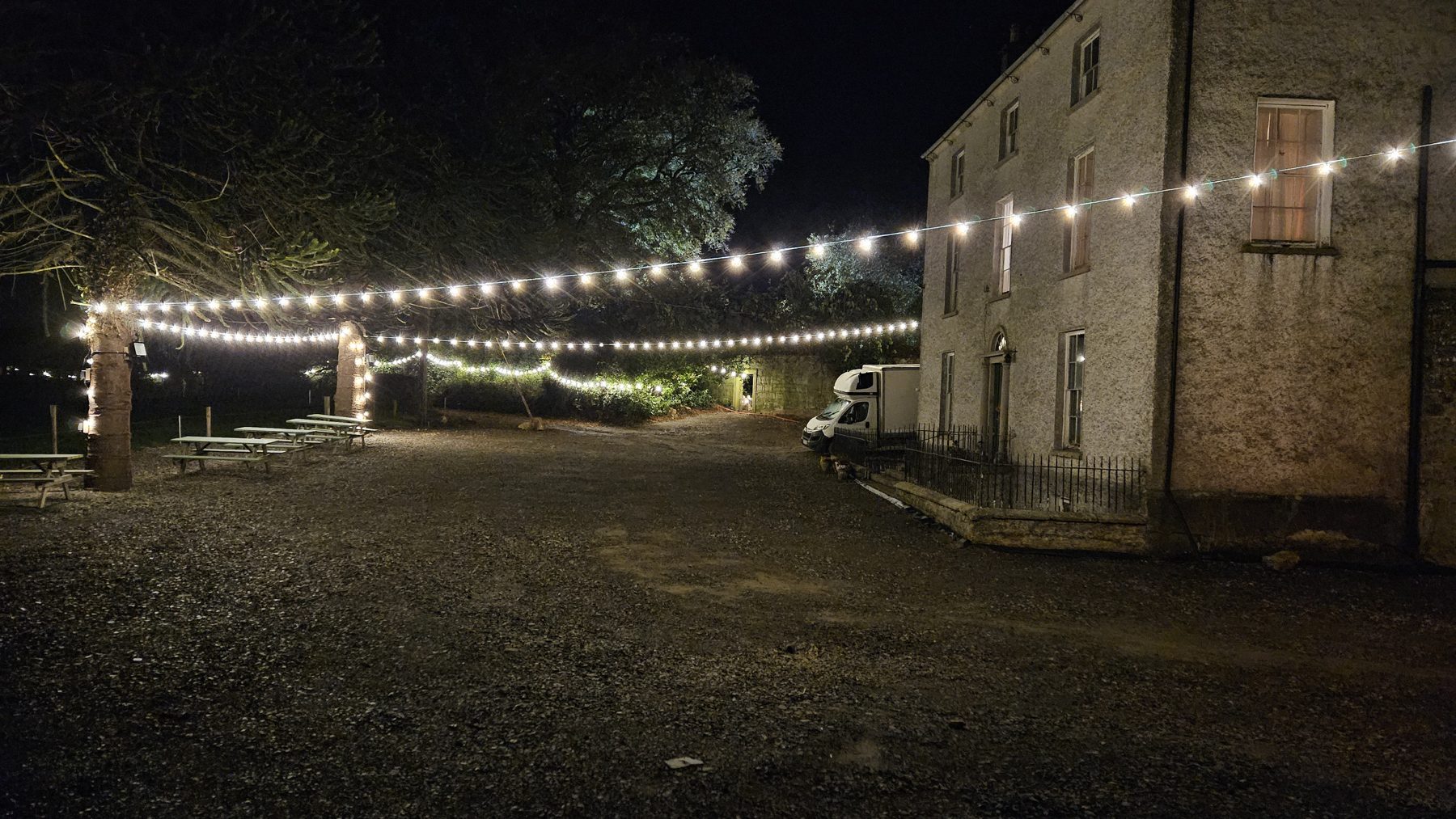 The avenue to Kyle Park lit with festoon lights at night